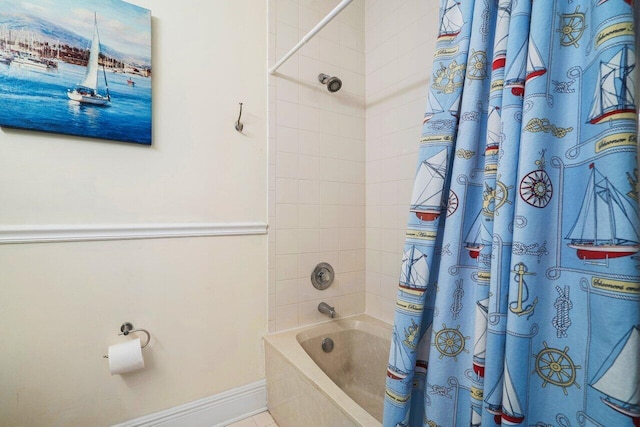 bathroom with shower / bath combo and tile patterned flooring