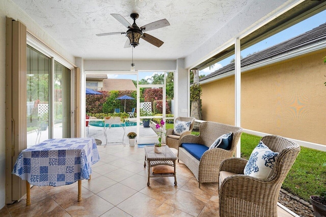 sunroom / solarium featuring ceiling fan