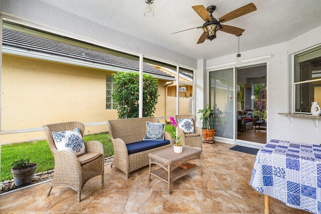 sunroom with ceiling fan