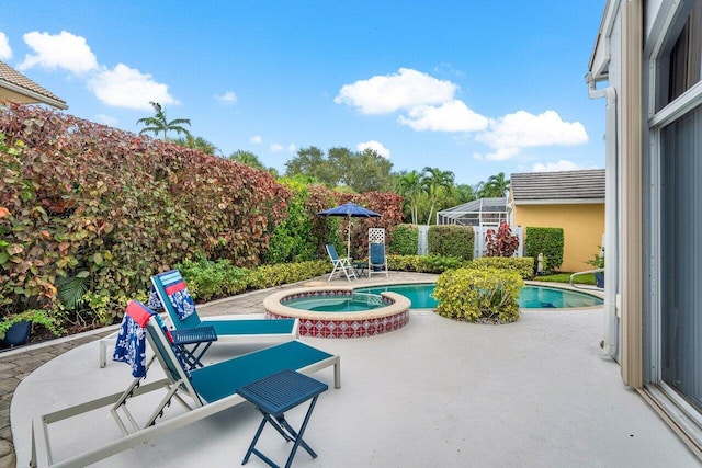 view of swimming pool with a patio, glass enclosure, and an in ground hot tub