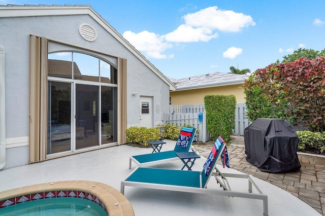 view of patio featuring grilling area and a hot tub