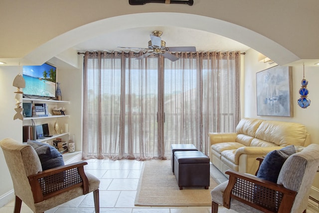 tiled living room featuring ceiling fan