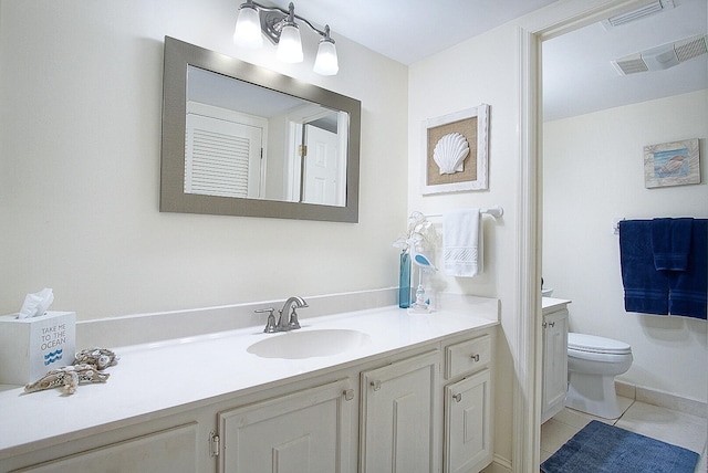 bathroom featuring tile patterned flooring, vanity, and toilet