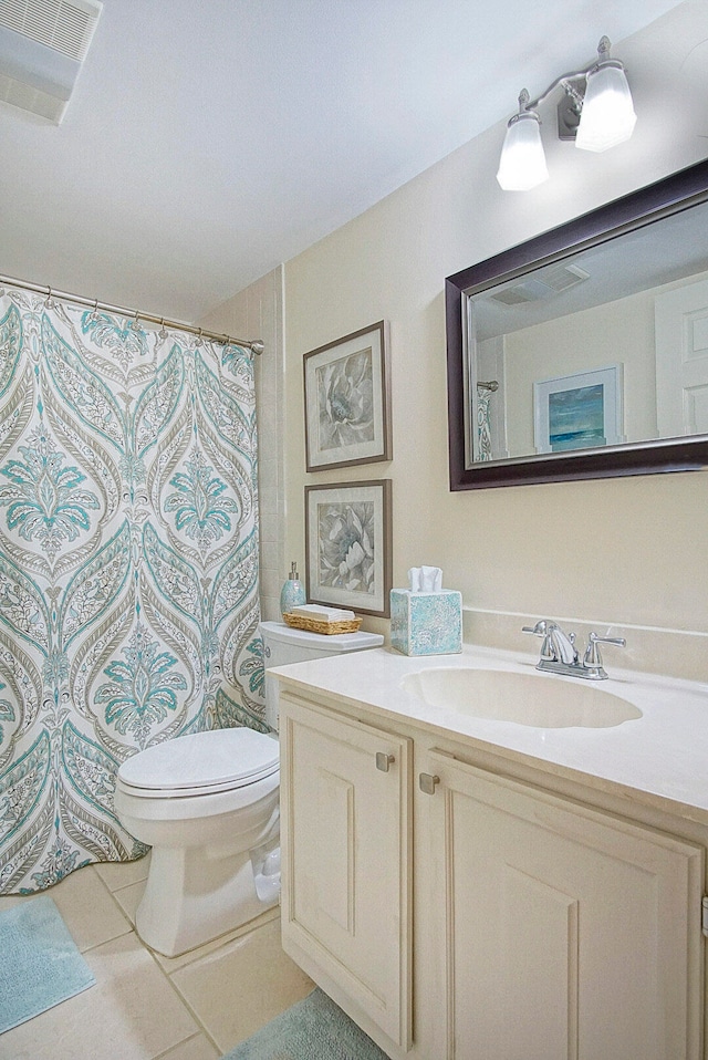 bathroom featuring tile patterned flooring, a shower with shower curtain, vanity, and toilet