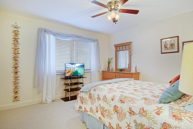 bedroom with ceiling fan and light colored carpet