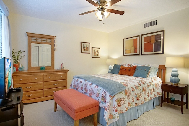 bedroom featuring light colored carpet and ceiling fan