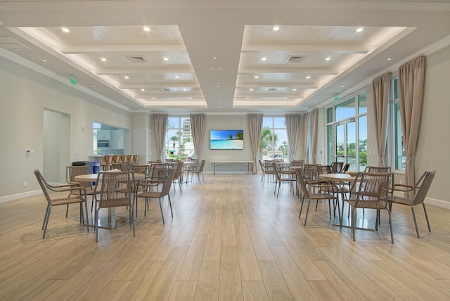 dining room with beamed ceiling and light wood-type flooring