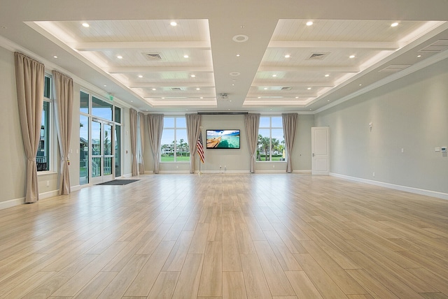 unfurnished living room featuring a tray ceiling, beam ceiling, and light hardwood / wood-style floors