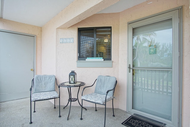 view of exterior entry featuring a patio area