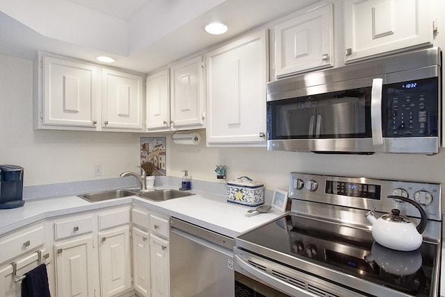 kitchen with white cabinets, appliances with stainless steel finishes, and sink