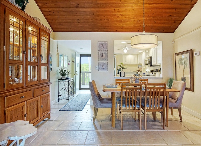 dining space featuring vaulted ceiling and wood ceiling