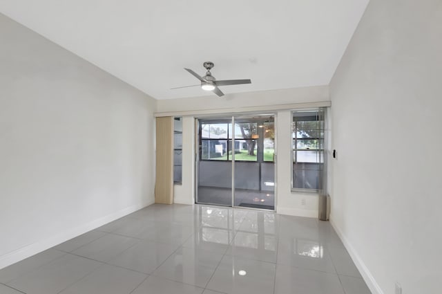 unfurnished room with ceiling fan and tile patterned flooring