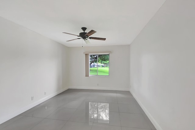 spare room featuring light tile patterned flooring and ceiling fan