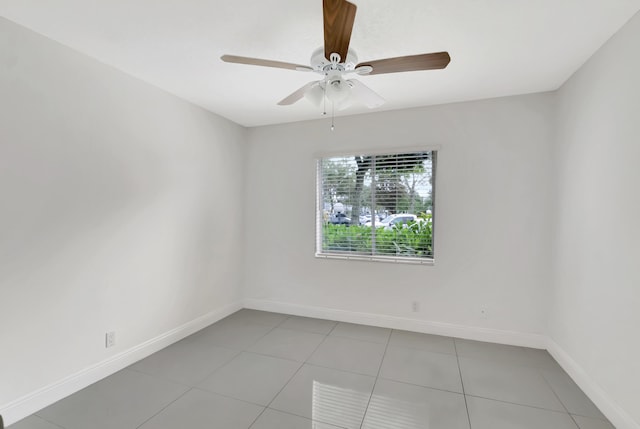 tiled spare room with ceiling fan