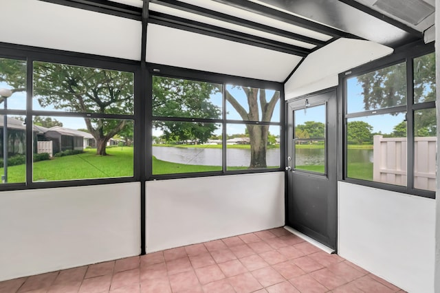 unfurnished sunroom featuring a water view