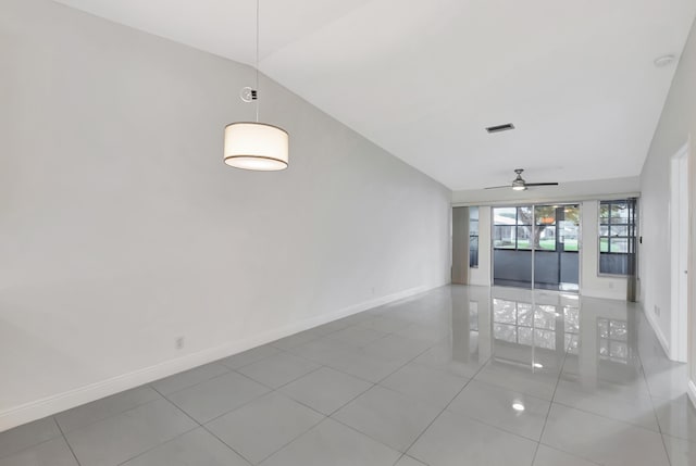 empty room featuring ceiling fan, lofted ceiling, and tile patterned floors