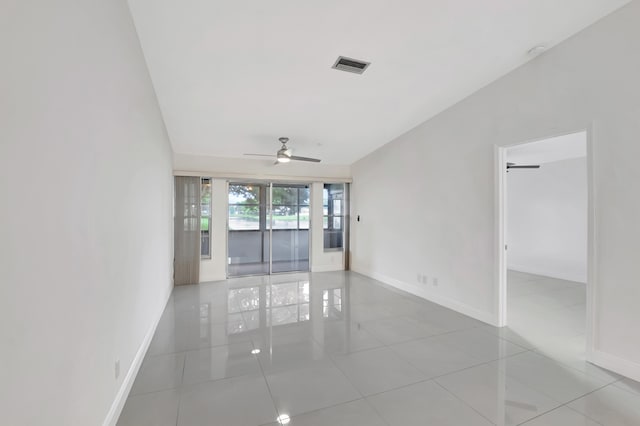 empty room with light tile patterned flooring and ceiling fan