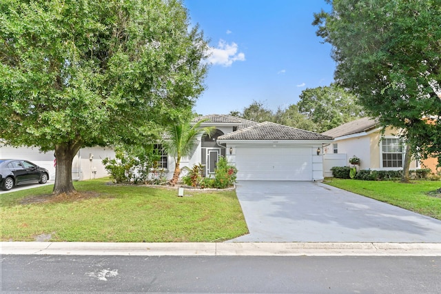 view of front of home with a front lawn and a garage