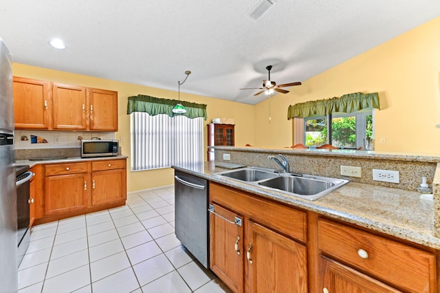 kitchen with light stone countertops, sink, hanging light fixtures, vaulted ceiling, and appliances with stainless steel finishes