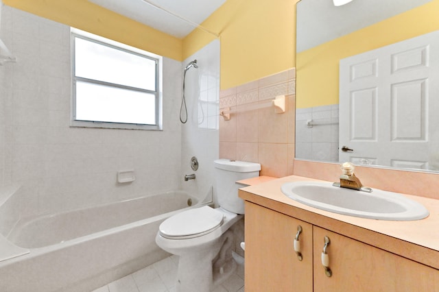 full bathroom with vanity, tile walls, tile patterned flooring, toilet, and tiled shower / bath