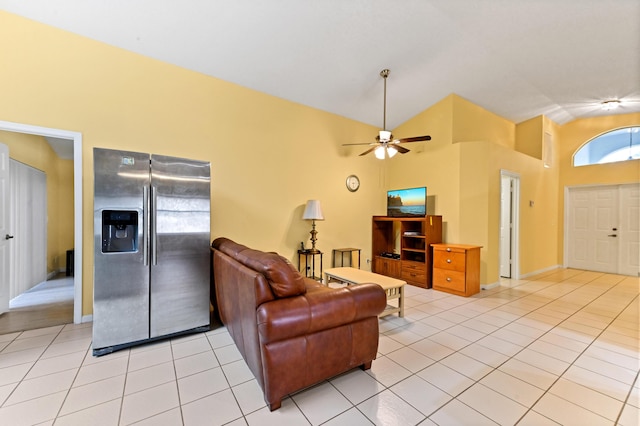 tiled living room with ceiling fan and high vaulted ceiling