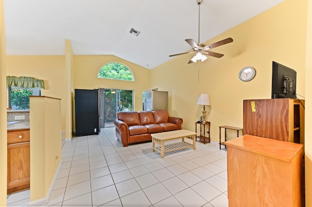 living room with ceiling fan, light tile patterned floors, and high vaulted ceiling