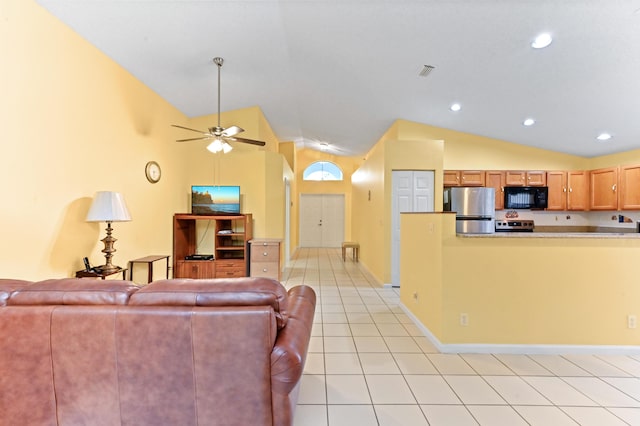 living room featuring ceiling fan, light tile patterned flooring, and vaulted ceiling