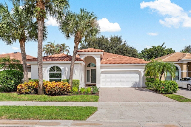 mediterranean / spanish home with a garage