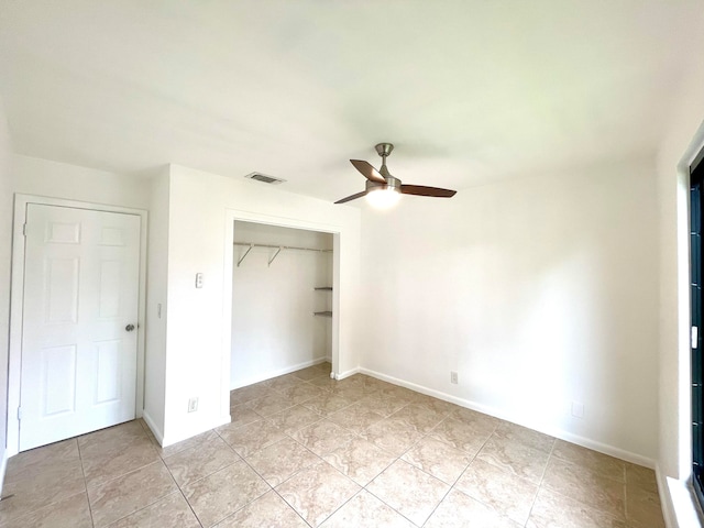 unfurnished bedroom featuring a closet, ceiling fan, and light tile patterned floors