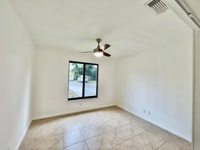 empty room featuring light tile patterned floors and ceiling fan