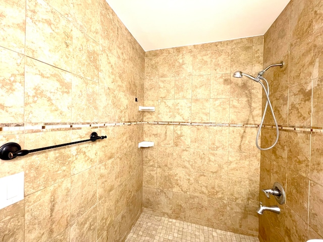 bathroom with a tile shower