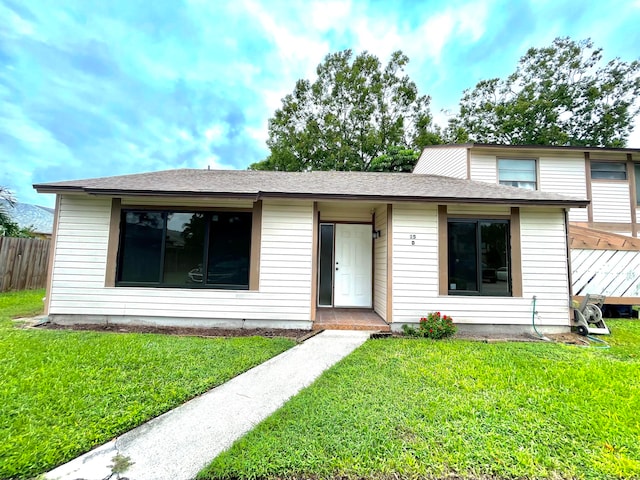 view of front of property featuring a deck and a front lawn