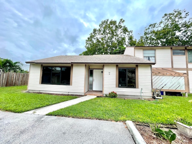 view of front of house with a front lawn and a wooden deck