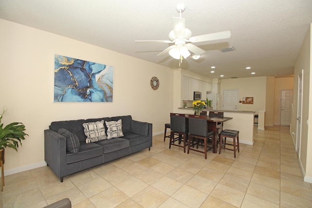 tiled living room featuring ceiling fan