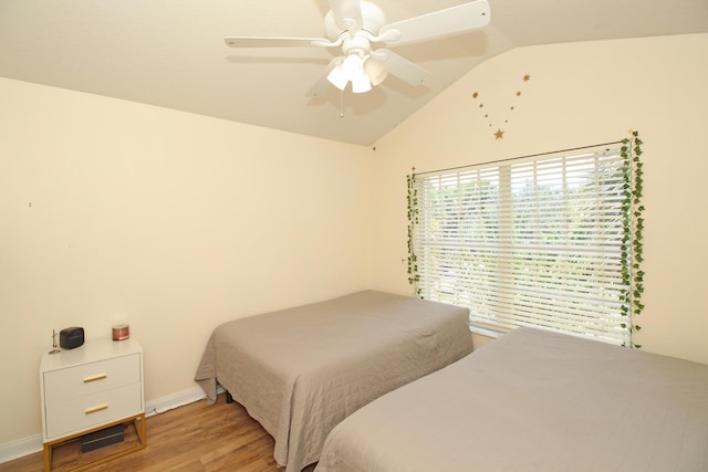 bedroom with light hardwood / wood-style flooring, ceiling fan, and lofted ceiling