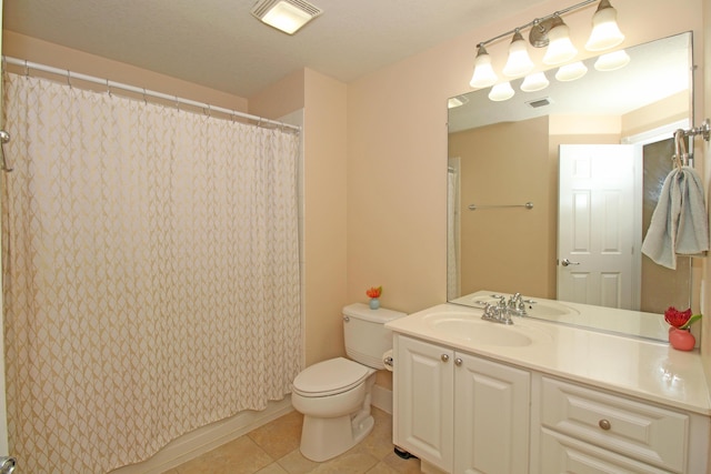 bathroom with tile patterned floors, vanity, toilet, and walk in shower