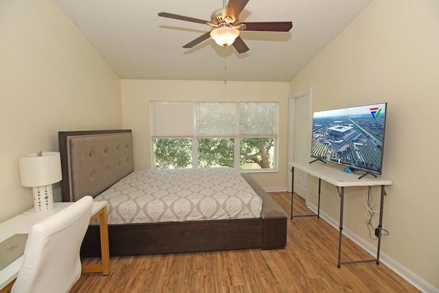 bedroom with wood-type flooring, vaulted ceiling, and ceiling fan