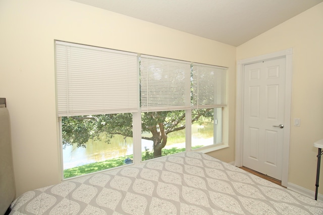 unfurnished bedroom featuring lofted ceiling