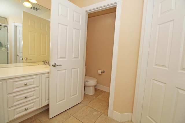 bathroom with toilet and tile patterned floors