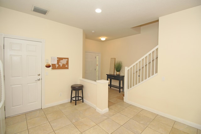 entryway with light tile patterned flooring