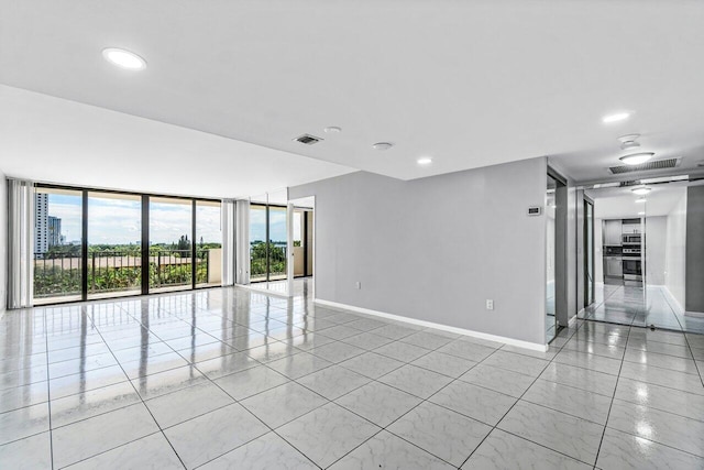 tiled empty room with a wall of windows