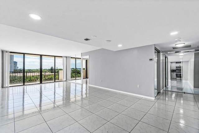 5600 N Flagler Dr Unit 505, West Palm Beach, FL 33407 - spare room featuring recessed lighting, visible vents, a wall of windows, and baseboards