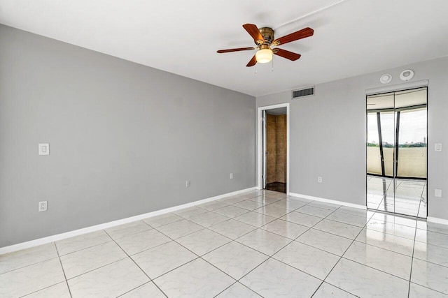 spare room featuring light tile patterned floors and ceiling fan