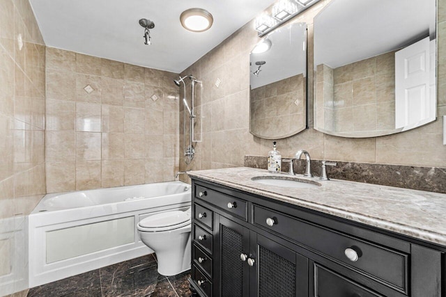 full bathroom with vanity, tile walls, tiled shower / bath combo, and toilet