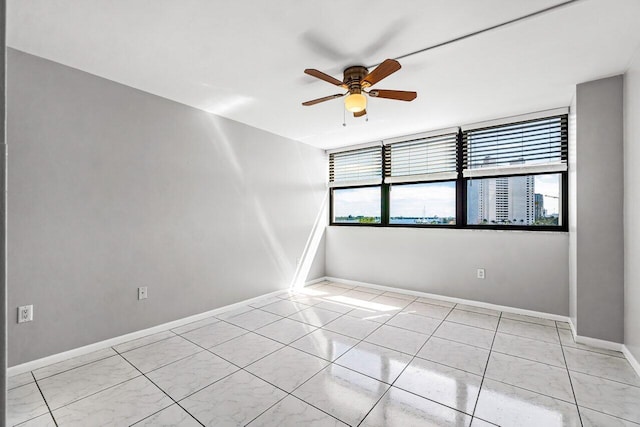 5600 N Flagler Dr Unit 505, West Palm Beach, FL 33407 - spare room with baseboards, a ceiling fan, and light tile patterned flooring