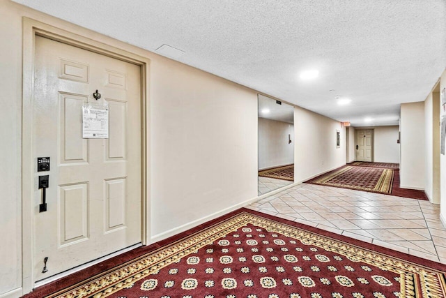 entrance foyer with tile patterned flooring and a textured ceiling