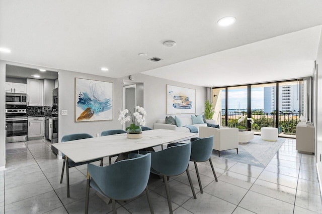 dining room featuring expansive windows and light tile patterned floors