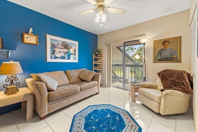 tiled living room with a textured ceiling and ceiling fan