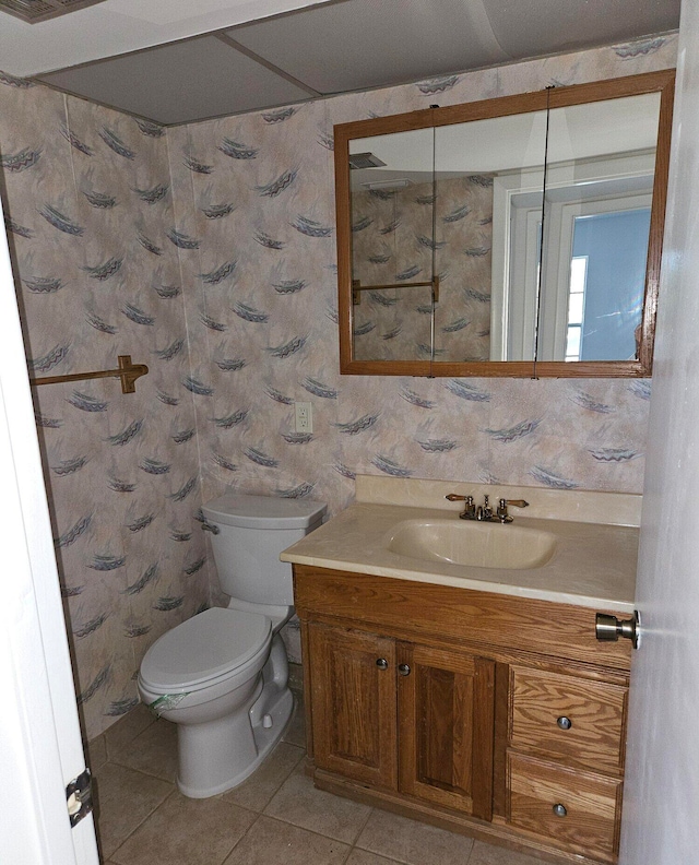 bathroom with tile patterned floors, vanity, and toilet