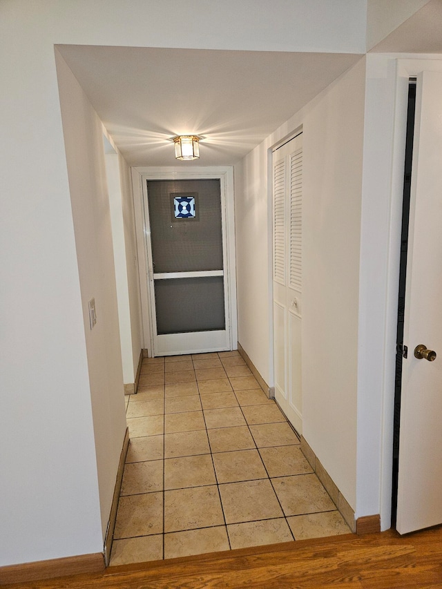 hallway featuring light tile patterned floors